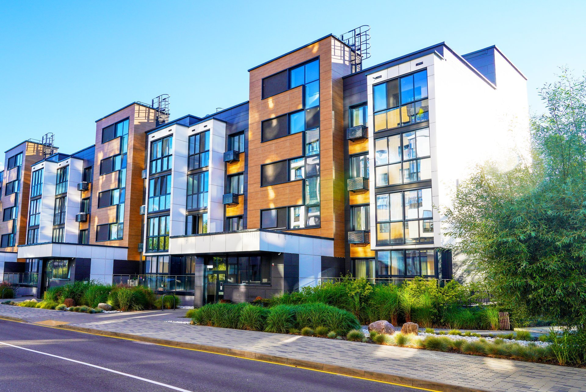 Modern residential apartment building with contemporary architecture and landscaping
