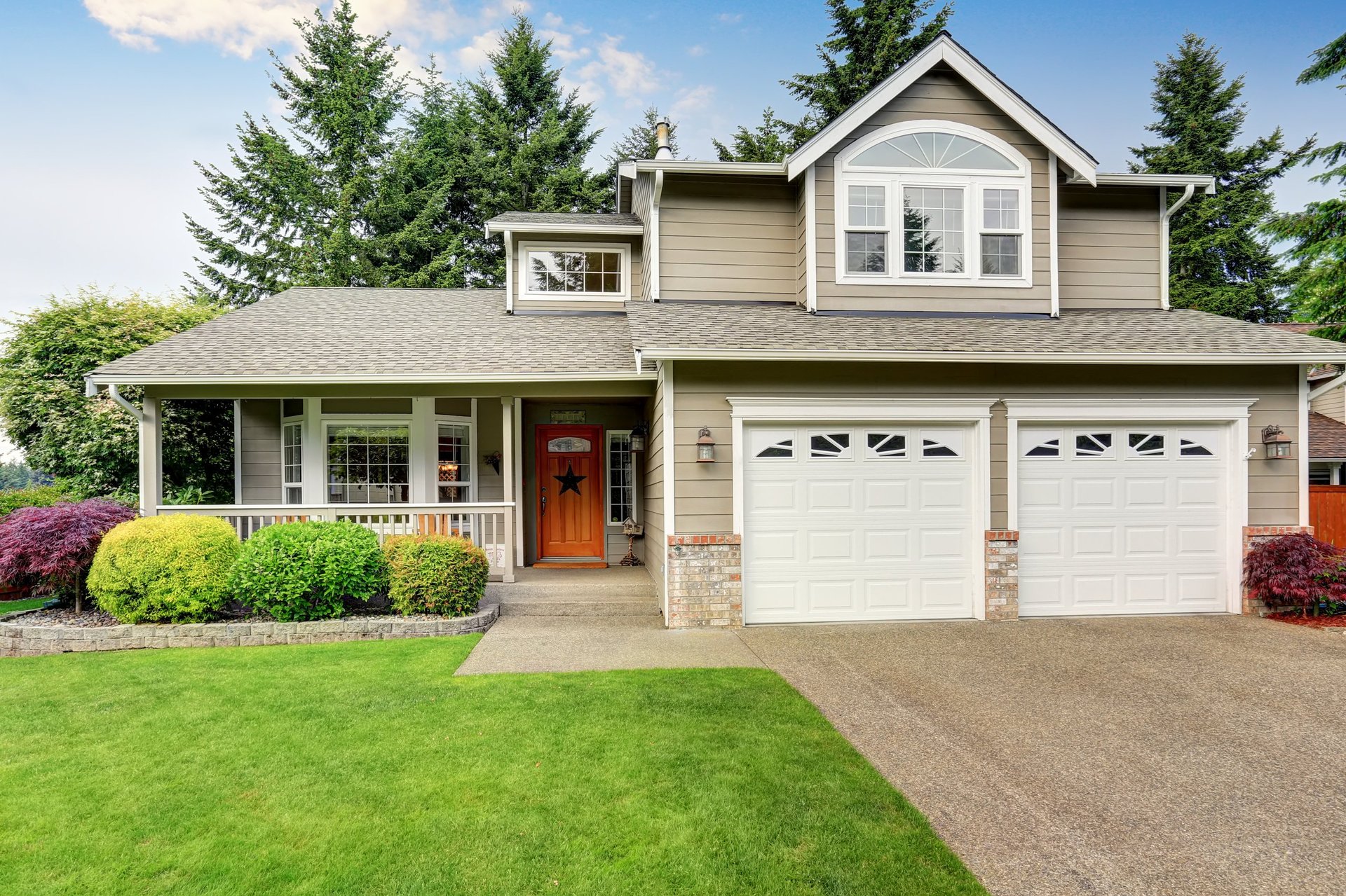 Beautiful American home exterior with well-kept lawn and double garage